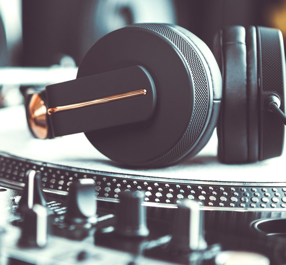 Headphones resting on a turntable in the booth